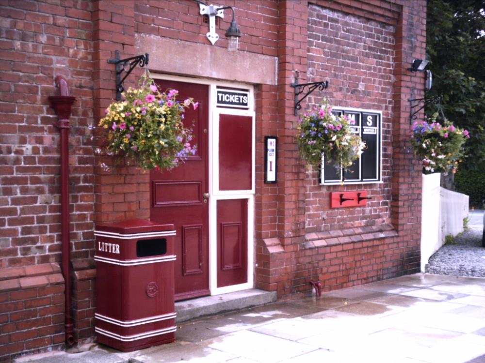 Ticket office with hanging baskets.