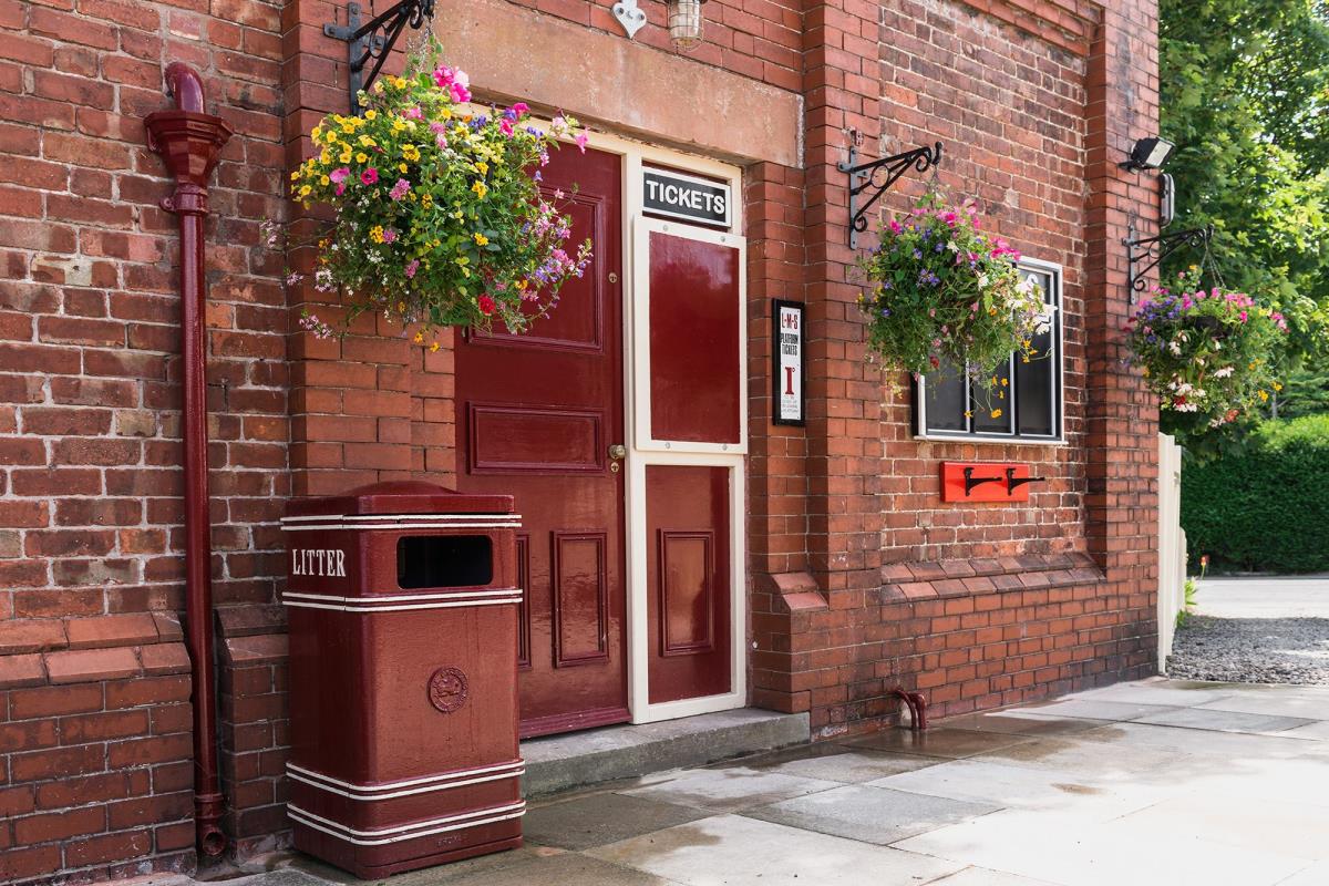 Flower baskets outside ticket office at Thornton Station.