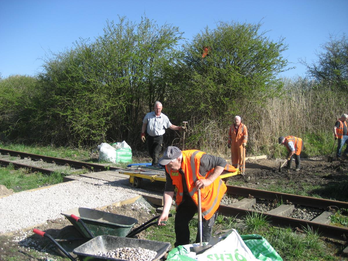 Laying gravel on the newly formed path.